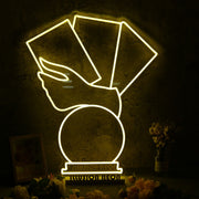 A Hand Holding Books Yellow Neon Sign