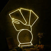 A Hand Holding Books Yellow Neon Sign