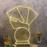 A Hand Holding Books Yellow Neon Sign