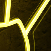 A Hand Holding Books Yellow Neon Sign