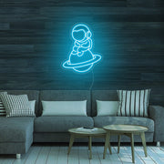 Astronaut Sitting On Planet Neon Sign