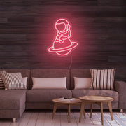 Astronaut Sitting On Planet Neon Sign