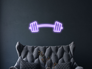 Barbell Neon Sign Hung On The Wall Of A Room