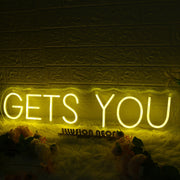 GETS YOU Yellow Neon Sign