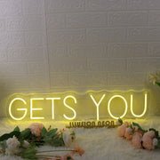 GETS YOU Yellow Neon Sign