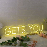 GETS YOU Yellow Neon Sign