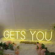 GETS YOU Yellow Neon Sign