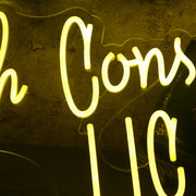 Kruah Consultants LLC Yellow Neon Sign