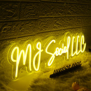 MJ Social LLC Yellow Neon Sign