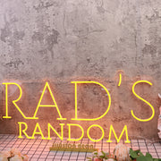 Rad's Random Orange Neon Sign