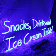 Snacks Drinks And Ice Cream Inside Blue Neon Sign